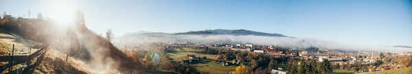 Panoramic view of beautiful mountains and Vorokhta town under blue sky, Carpathians, Ukraine