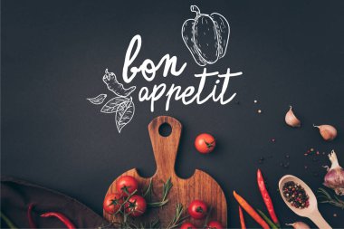 bon olsun yazı ile gri tabloda kiraz domates ve sarımsak ile rezene üstten görünüm
