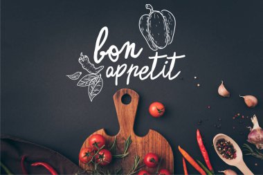 top view of cherry tomatoes and fennel with garlic on gray table with bon appetit lettering clipart