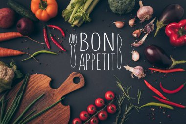 top view of different vegetables and cutting board on table with bon appetit lettering clipart