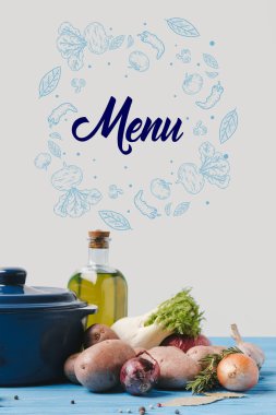 pan with ripe organic vegetables and olive oil on table in kitchen, menu lettering clipart