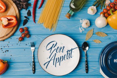 top view of ingredients for cooking pasta on blue table, bon appetit lettering