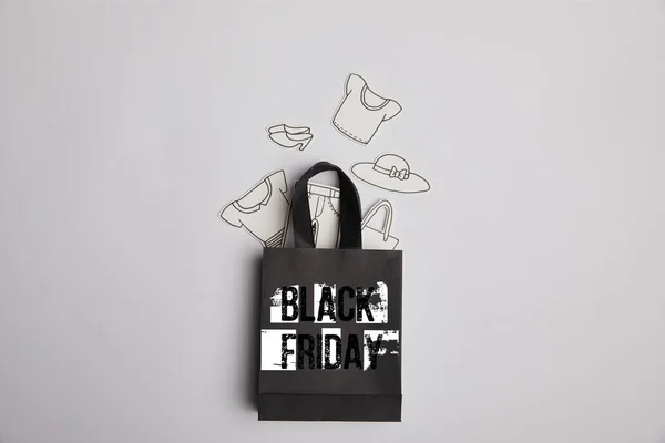 Top View Black Shopping Bag Black Friday Inscription Paper Clothes — Stock Photo, Image