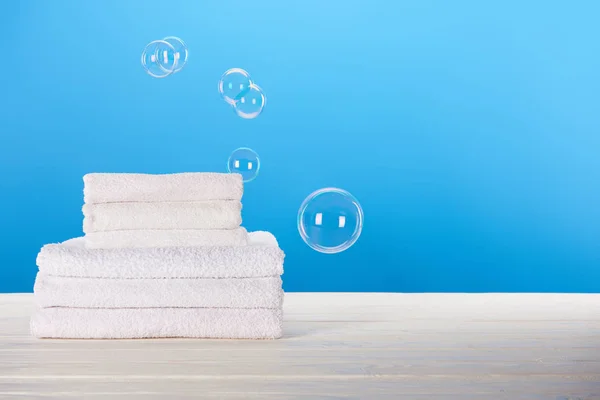 Close View Clean White Towels Soap Bubbles Blue Background — Stock Photo, Image