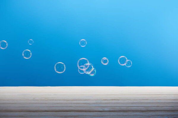 clean laundry soap bubbles on blue background 