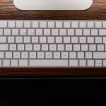 Top view of computer keyboard with graphics tablet on wooden table