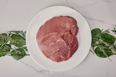 top view of fresh raw meat on plate with herbs on white background clipart