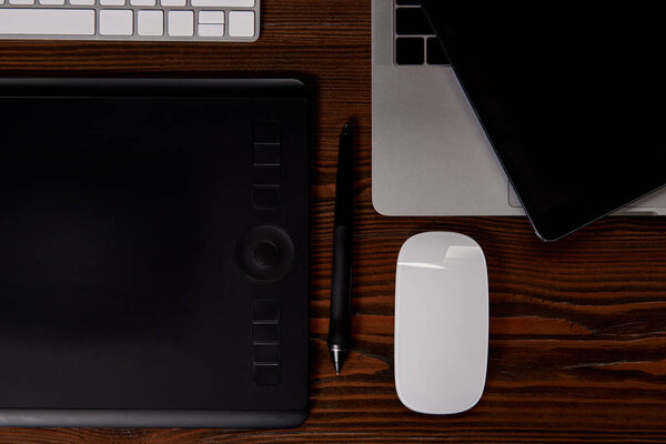 top view of graphics designer workplace on wooden table