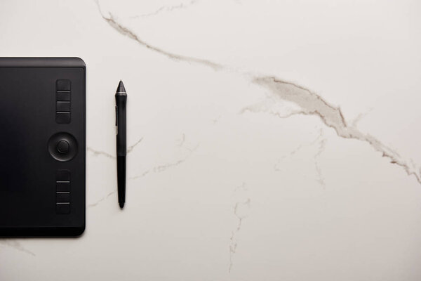 top view of graphics tablet on white marble surface