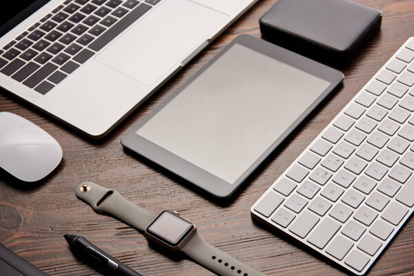 close-up shot of different modern gadgets on wooden table