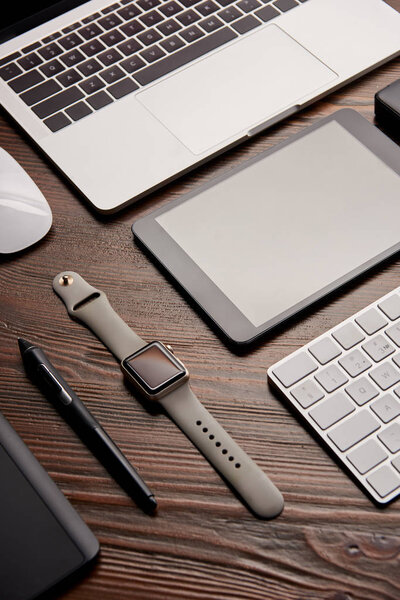close-up shot of various modern gadgets on wooden table