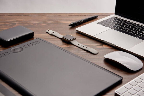 close-up shot of cg artist gadgets on wooden table