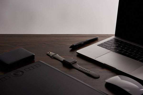 close-up shot of retoucher gadgets on wooden table