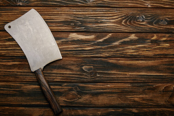 top view of butcher knife on wooden background