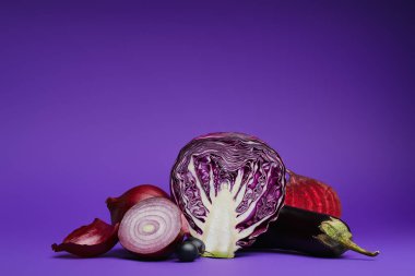 sliced cabbage, onions, grapes, beetroot and eggplant on purple clipart