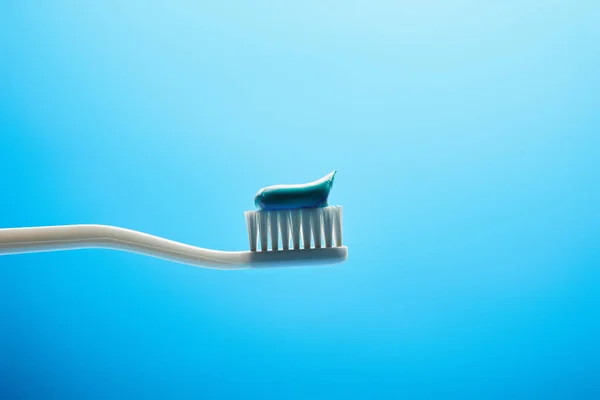 Zamknij Widok Szczoteczki Zębów Pastą Niebieskim Tle — Zdjęcie stockowe