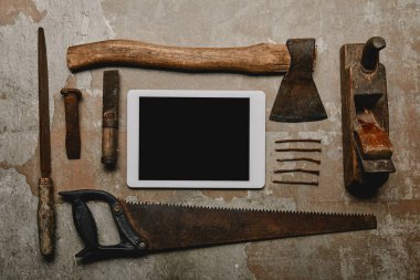 Flat lay with different carpentry tools and digital tablet on old surface clipart