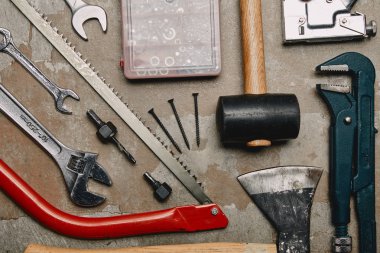 Flat lay with set of tools and smartphone on wooden background clipart