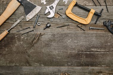 Top view of different carpentry tools on wooden background clipart