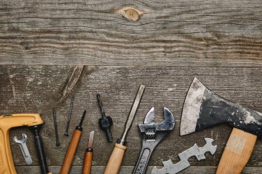 Top view of various carpentry tools on wooden background clipart
