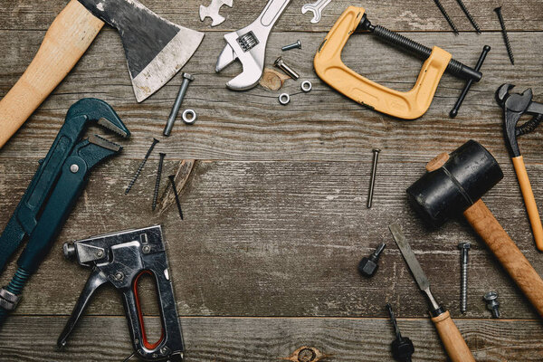 Top view of set of tools on wooden background