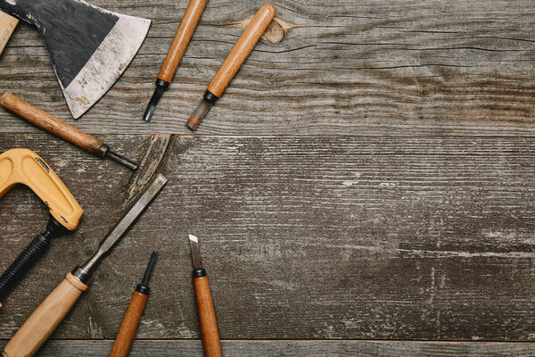 Top view of various carpentry tools on wooden background