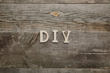 Top view of wooden diy sign on wooden background clipart