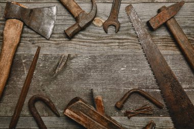 Top view of various tools on wooden background clipart