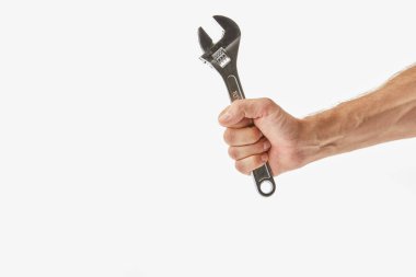 Partial view of man holding monkey wrench isolated on white clipart