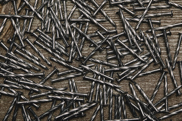 Top view of nails arranged on wooden table