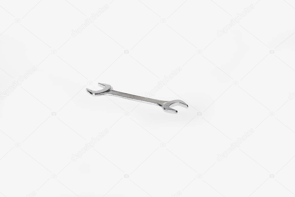 Silver colored wrench tool isolated on white