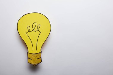 top view of yellow light bulb idea symbol on grey background clipart