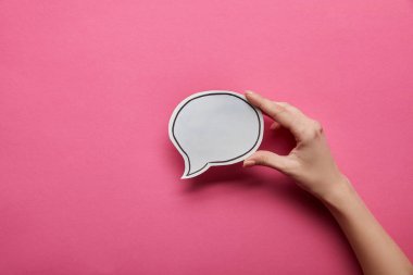 top view of empty white speech bubble on pink background