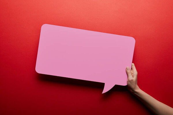 top view of empty speech bubble in pink color on red background