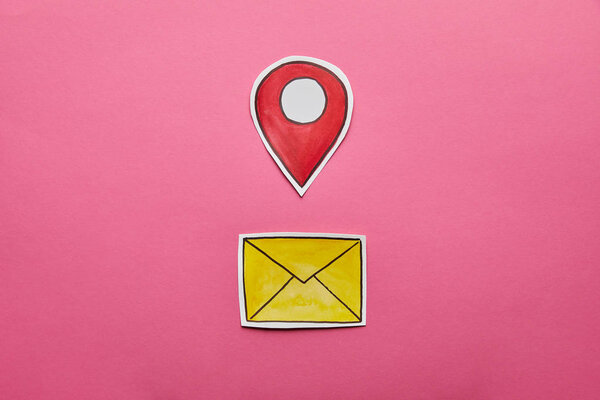 yellow mail sign with red geolocation on pink background