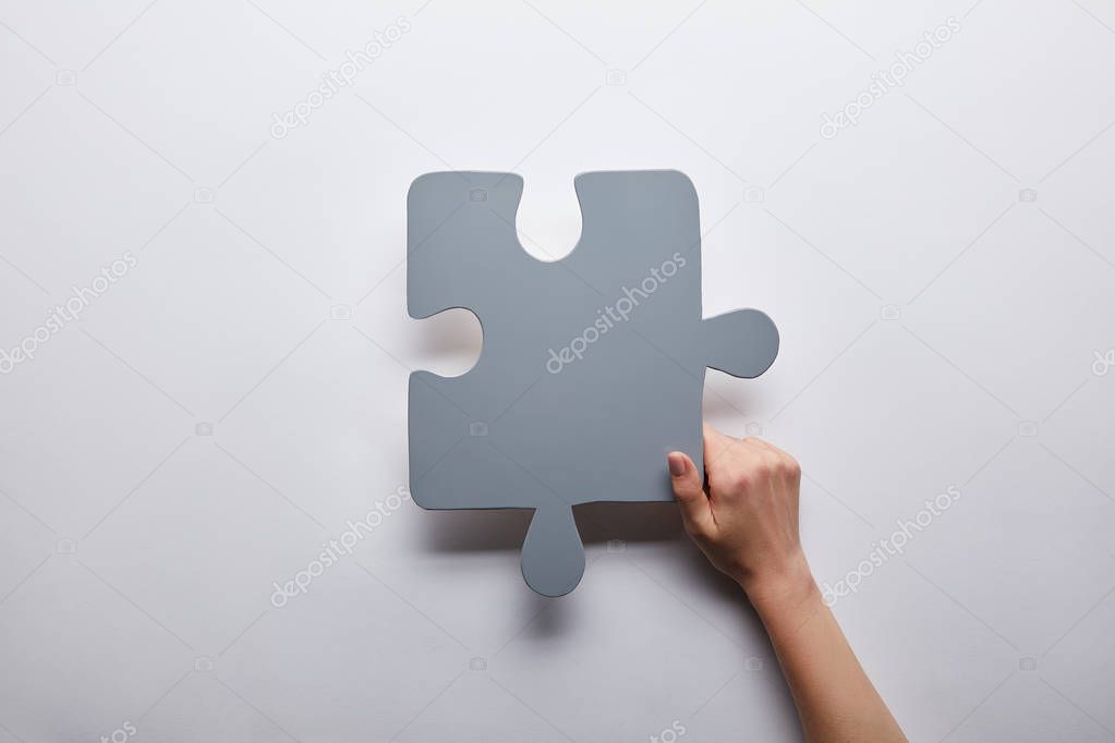 top view of grey puzzle problem solution symbol on grey background 