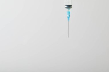 close up of syringe for injection isolated on grey with copy space