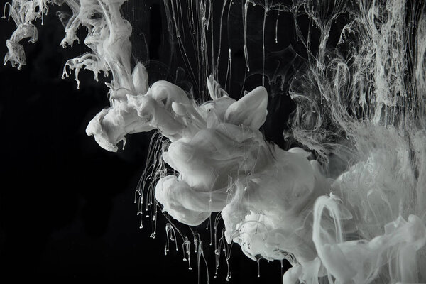 grey acrylic paint splash in water on black background