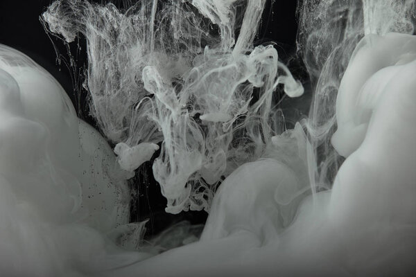 abstract flowing swirls of monochrome paint in water