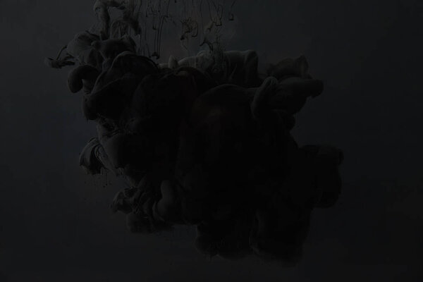 black acrylic paint splash on dark background