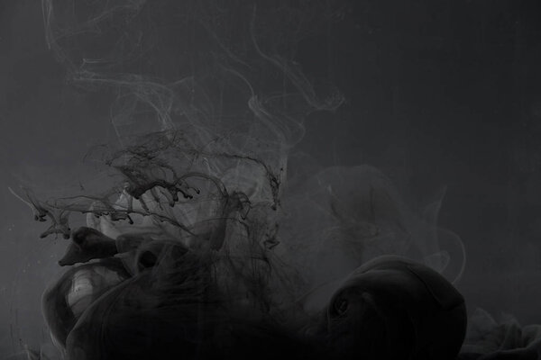 dark swirls of paint on grey background