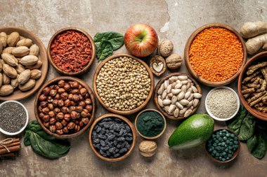top view of superfoods, legumes and healthy ingredients on rustic background clipart