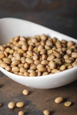 selective focus of soybean in white bowl on table clipart