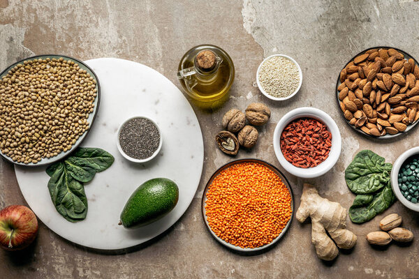 top view of superfoods, legumes and healthy ingredients on rustic background