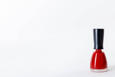 bottle of bright red nail polish on white clipart