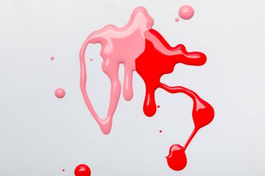 pembe ve kırmızı oje gri izole damla damlama üstten görünüm 