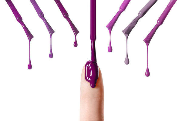 messy drop of purple nail polish dripping on nail isolated on white 