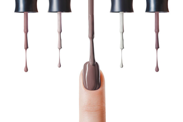 brown nail polish on fingernail with wet brush isolated on white 
