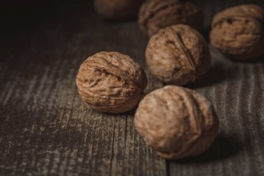 close up view of tasty walnuts on wooden surface clipart
