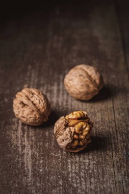 close up view of natural walnuts on wooden tabletop clipart